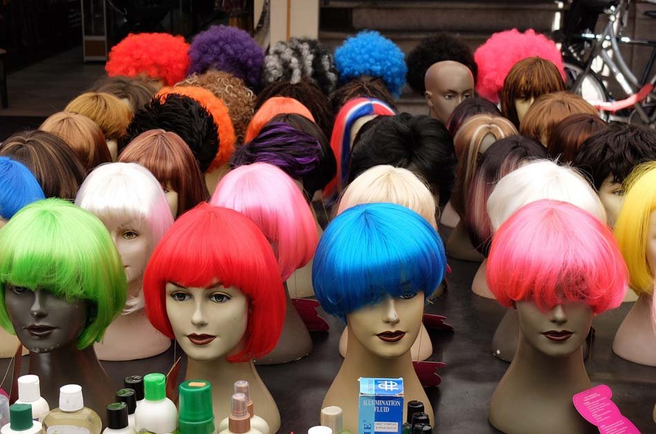 several mannequins each wearing a wig